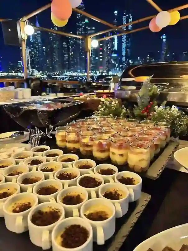 Exquisite dining setup on a dhow cruise party, showcasing a delectable array of gourmet dishes and beverages