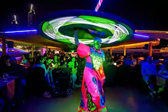 A captivating tanoura dance performance during a dhow cruise party and the performer dressed in colorful traditional attire